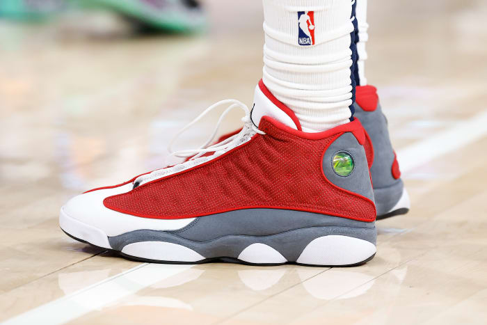 View of red, grey, and white Air Jordan shoes.